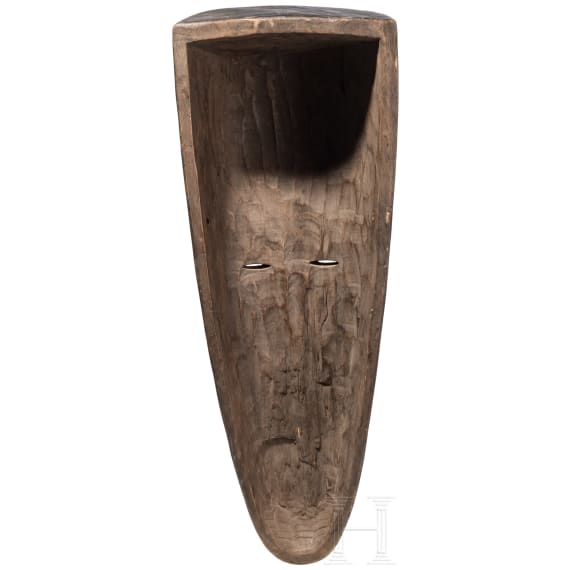 A Gabonese reliquary guardian figure and a Ngil-mask of the Fang people