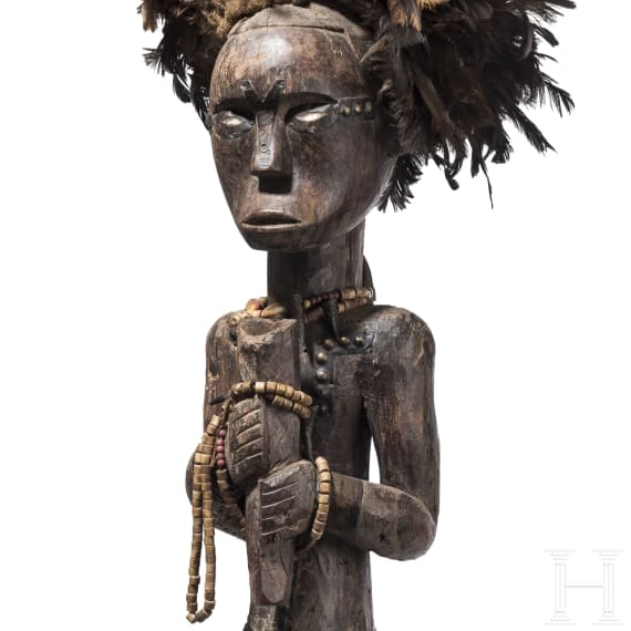 A Gabonese reliquary guardian figure and a Ngil-mask of the Fang people