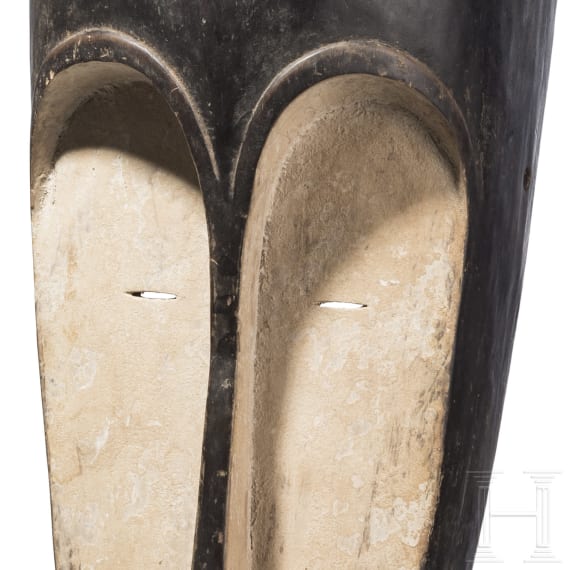 A Gabonese reliquary guardian figure and a Ngil-mask of the Fang people