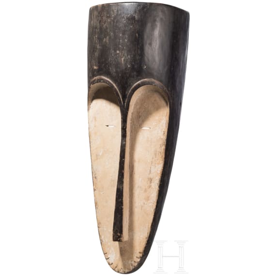 A Gabonese reliquary guardian figure and a Ngil-mask of the Fang people