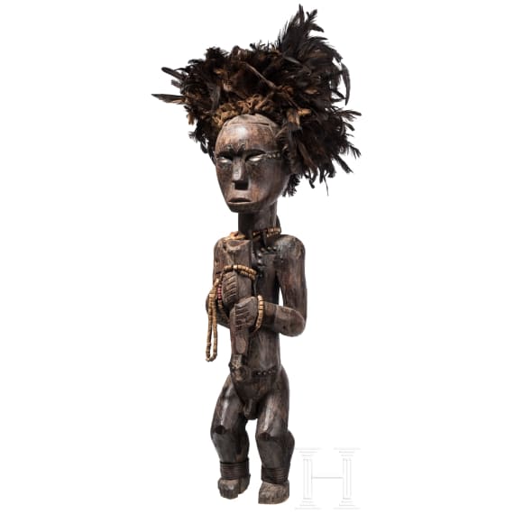 A Gabonese reliquary guardian figure and a Ngil-mask of the Fang people