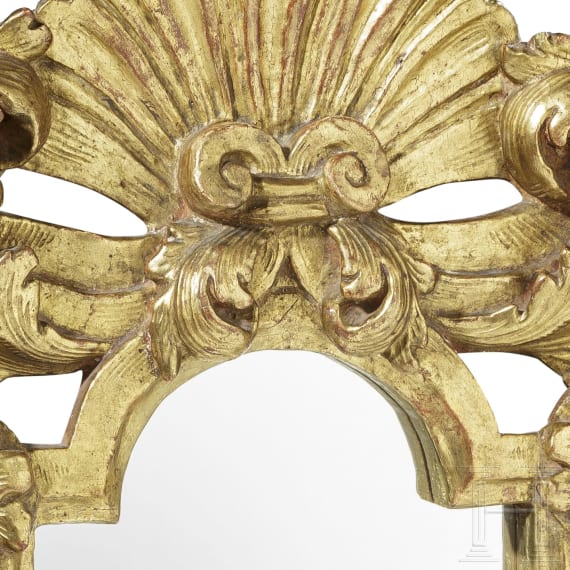 A mirror in a carved frame, probably German, 19th century