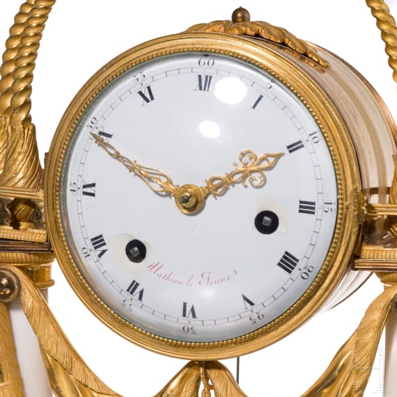 A gilt-bronze and alabaster table clock, an enamel and brass stoup and a putto, French, Paris, circa 1780 (clock)/late 19th century