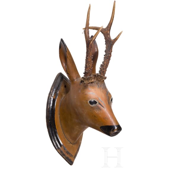 A German/Austrian roebuck trophy on a carved wooden head, circa 1800