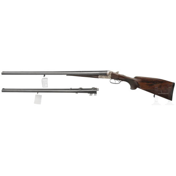 A side by side combination gun with extra side by side shotgun barrel in case