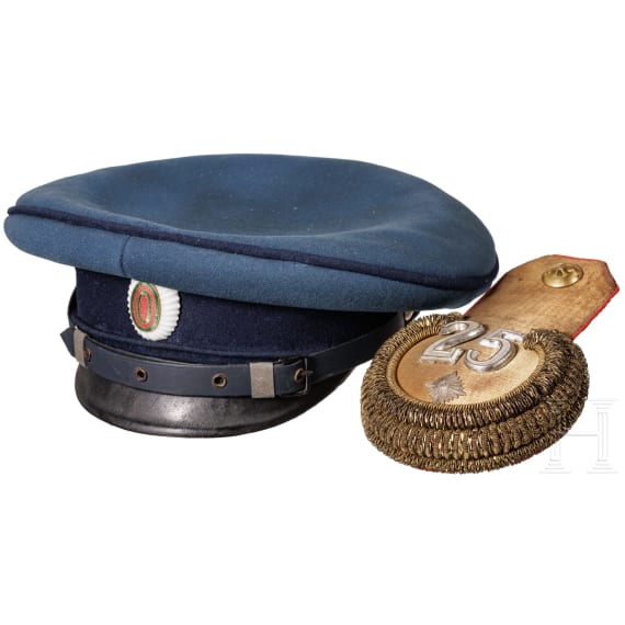 A peaked cap for officers (probably a military doctor) and an epaulette for a first lieutenant, World War I