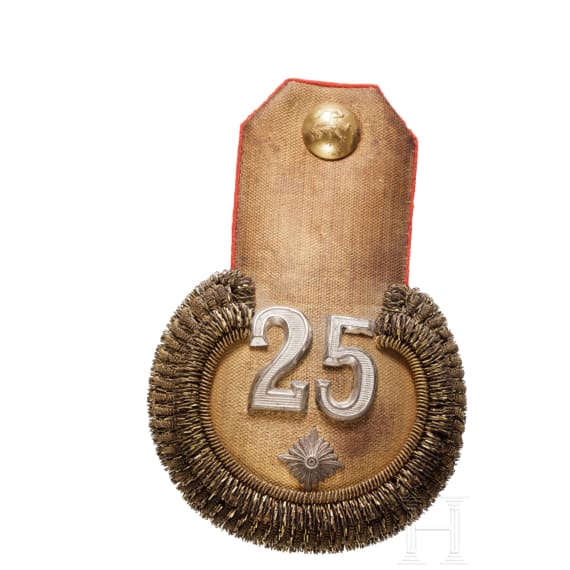 A peaked cap for officers (probably a military doctor) and an epaulette for a first lieutenant, World War I