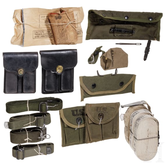 A group of US military equipment with sling, magazine pouches and cleaning accessories