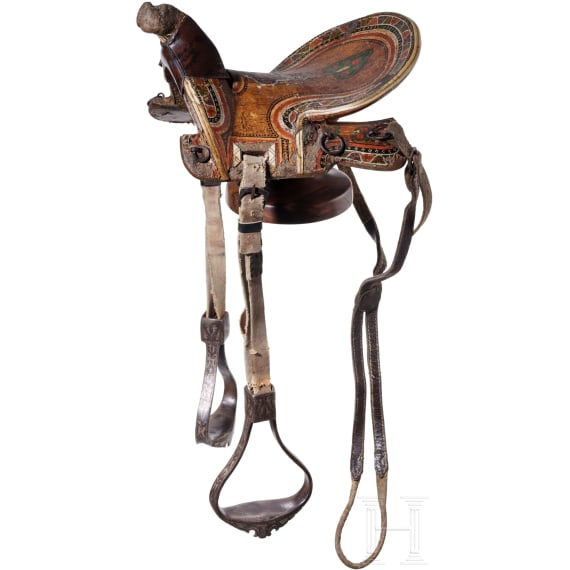 An Indopersian saddle with silver damascened stirrups, 19th century