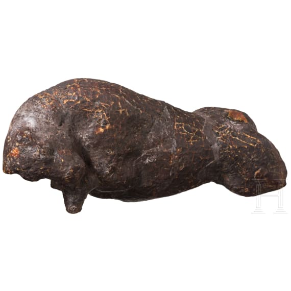 An amber figure of a lying bull, Greek, 4th century B.C.