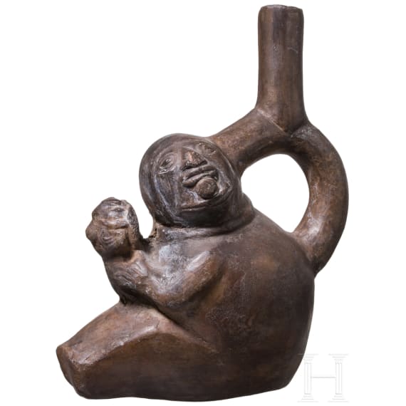 A Peruvian animal-head shaped clay vessel, probably Chimu culture, 11th - 15th century