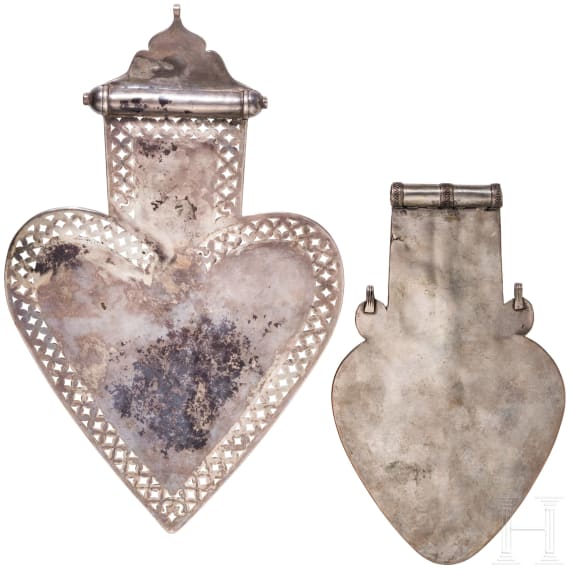 Two heart-shaped and partially gilt Turkmen silver and carnelian Teke "asyk" back-pendants, circa 1900