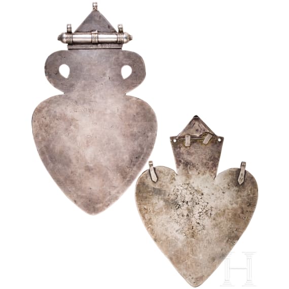 Two heart-shaped and partially gilt Turkmen silver and carnelian Teke "asyk" back-pendants, circa 1900