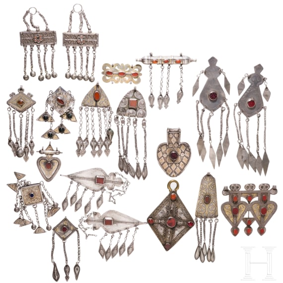 19 partially gilt Turkmen silver and carnelian pendants, circa 1900