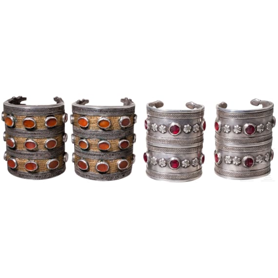Two pairs of partially fire-gilt Turkmen silver and carnelian cuff bracelets, circa 1900