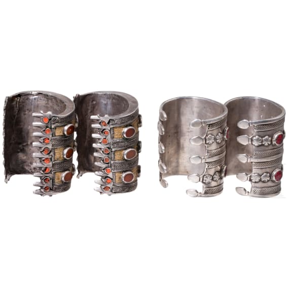 Two pairs of partially fire-gilt Turkmen silver and carnelian cuff bracelets, circa 1900