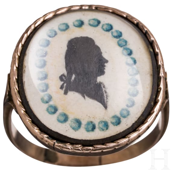 A 8ct gold ring with two portraits