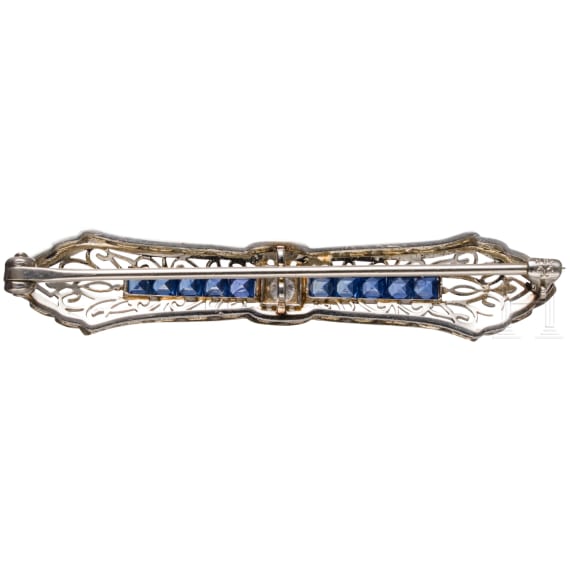 A 14ct gold brooch set with sapphires and diamond