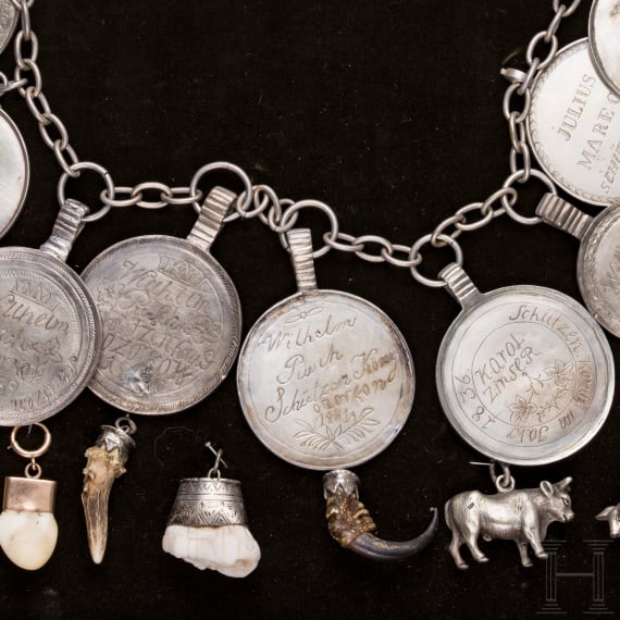 A group of German and Polish silver trinkets including a shooting champion's necklace, 19th century