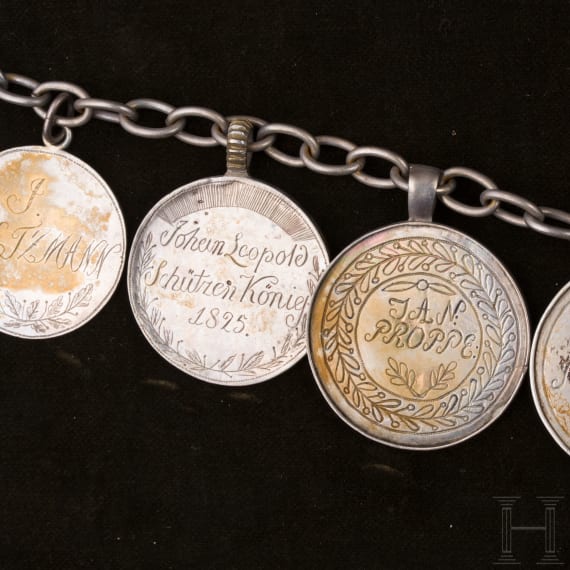 A group of German and Polish silver trinkets including a shooting champion's necklace, 19th century