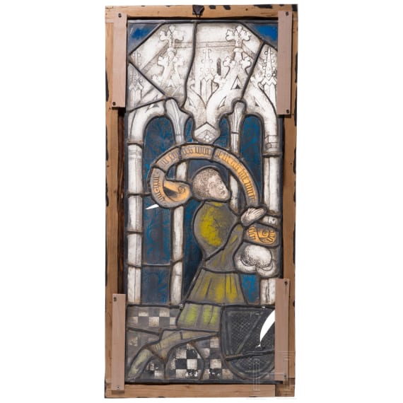 A German leaded stained glass window showing a praying donor, mid 15th century