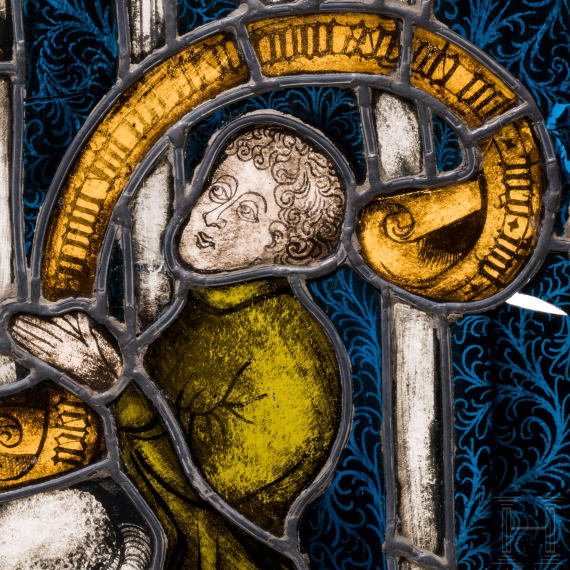 A German leaded stained glass window showing a praying donor, mid 15th century