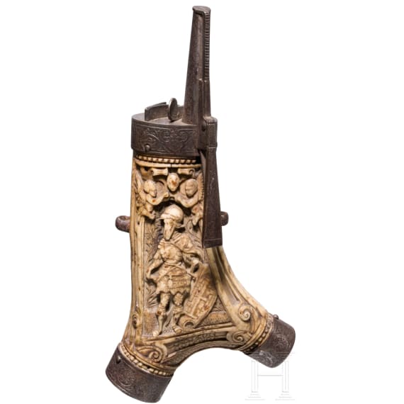 A fine South German carved staghorn powderflask with etched mountings, dated 1597