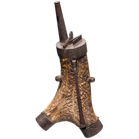 A fine South German carved staghorn powderflask with etched mountings, dated 1597
