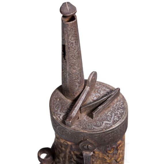A fine South German carved staghorn powderflask with etched mountings, dated 1597