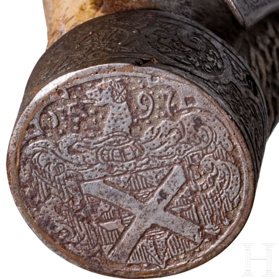 A fine South German carved staghorn powderflask with etched mountings, dated 1597