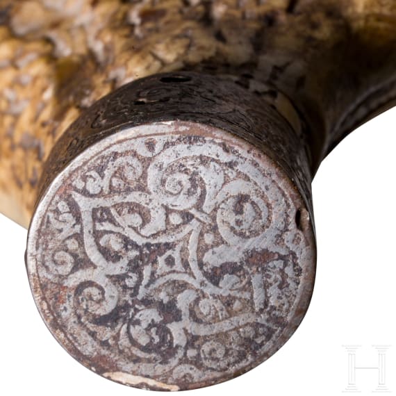 A fine South German carved staghorn powderflask with etched mountings, dated 1597