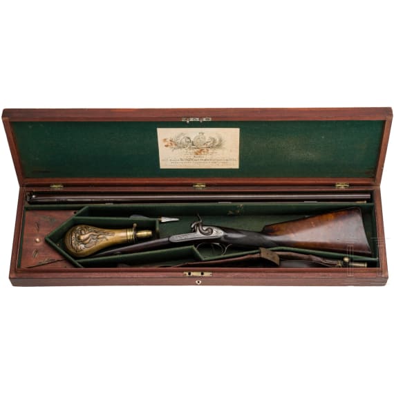 A side-by-side shotgun by J. Manton in London, with case