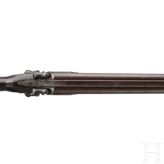 A side-by-side shotgun by J. Manton in London, with case