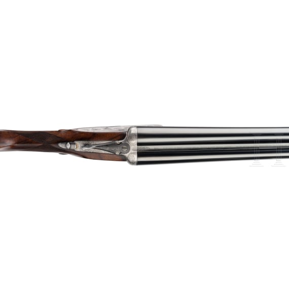 A side-by-side shotgun by Purdey & Sons, London, in case