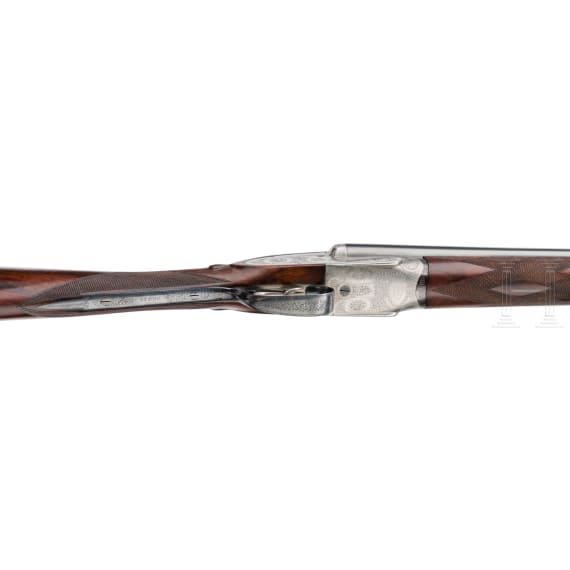 A side-by-side shotgun by Purdey & Sons, London, in case
