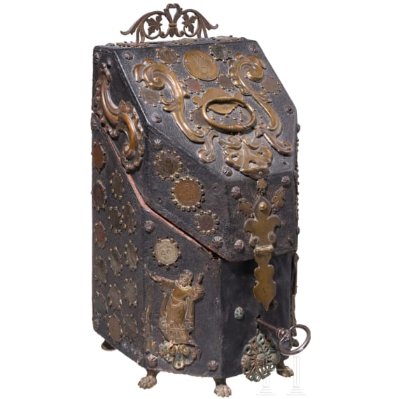 A copper and coin-mounted leather cutlery casket