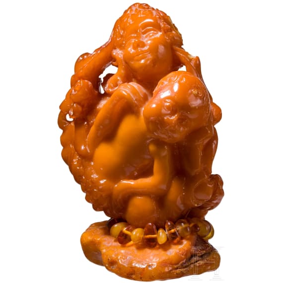 A figural amber carving showing a mother with her child