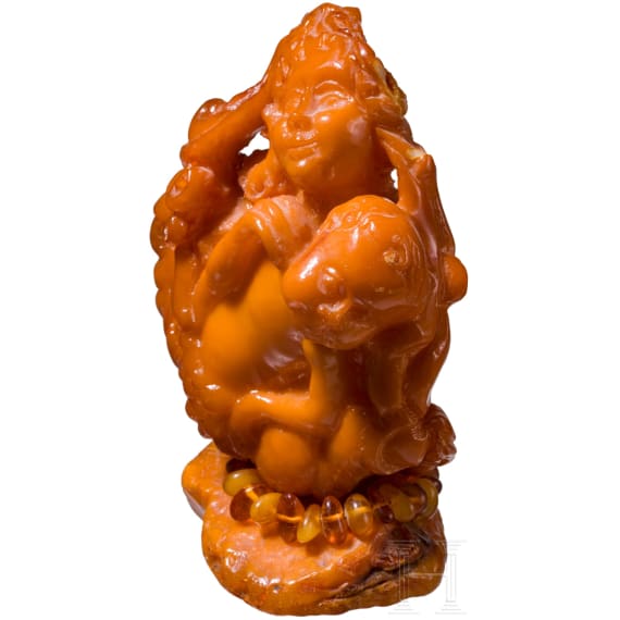 A figural amber carving showing a mother with her child