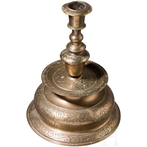 A large engraved Nuremberg brass bell-bottom candlestick, ca. 1670/80