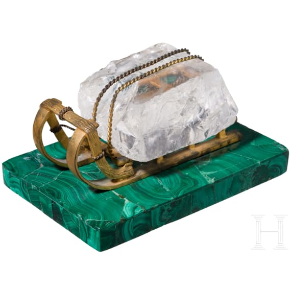 A Russian gilt-bronze sledge-shaped paperweight on a malachite stand, 20th century
