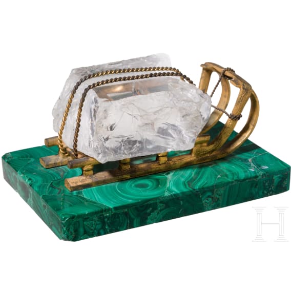 A Russian gilt-bronze sledge-shaped paperweight on a malachite stand, 20th century