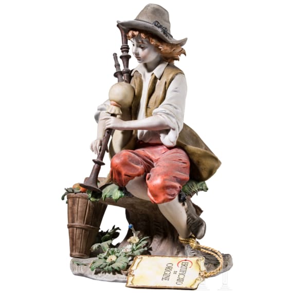 Two Italian biscuit porcelain figures (couple) of a boy with bagpipe and a girl feeding a goat, Benaccio (design), Capodimonte, Triade, 20th century