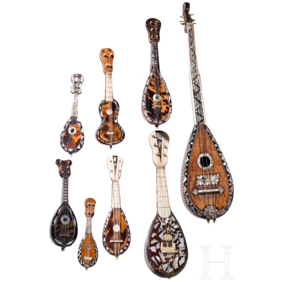 A group of seven miniature tortoiseshell and mother-of-pearl inlaid mandolins and one miniature guitar, Italy, late 19th / early 20th century
