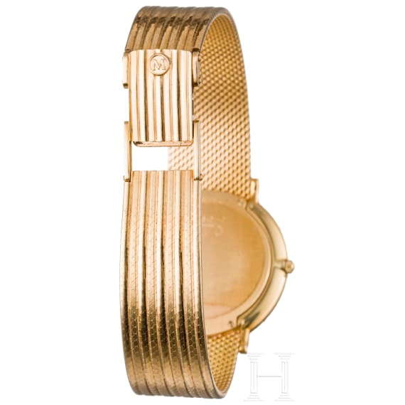 An 18-carat gold and quartz black dial Movado wristwatch with presentation box