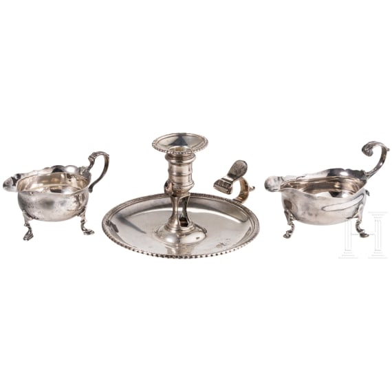 An English silver hand candlestick and two sauce boats, London, 18th century