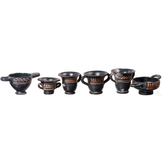 18 miniature vessels made of black glazed pottery, southern Italy, 4th &ndash; 3rd century B.C.