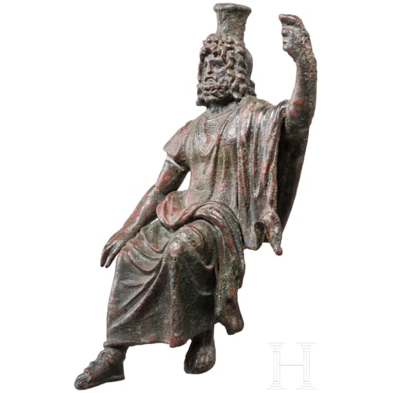 An enthroned Roman bronze statuette of Serapis, 2nd - 3rd century