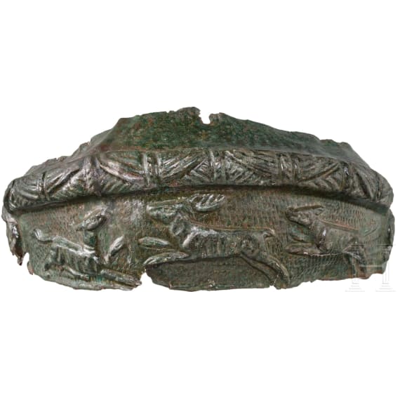 Frontal plate made of bronze sheet from a Roman helmet with an inscription, along with four fragments of an armour clasp, Roman, 2nd &ndash; early 3rd century A.D.