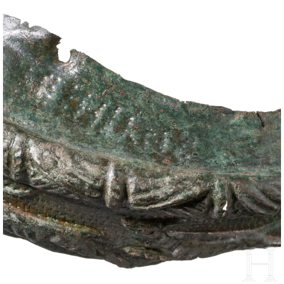 Frontal plate made of bronze sheet from a Roman helmet with an inscription, along with four fragments of an armour clasp, Roman, 2nd &ndash; early 3rd century A.D.