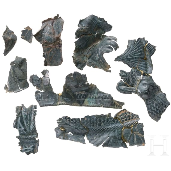 Ten fragments of a Roman helmet, partly pieced together from shards, late 2nd &ndash; first half of the 3rd century.